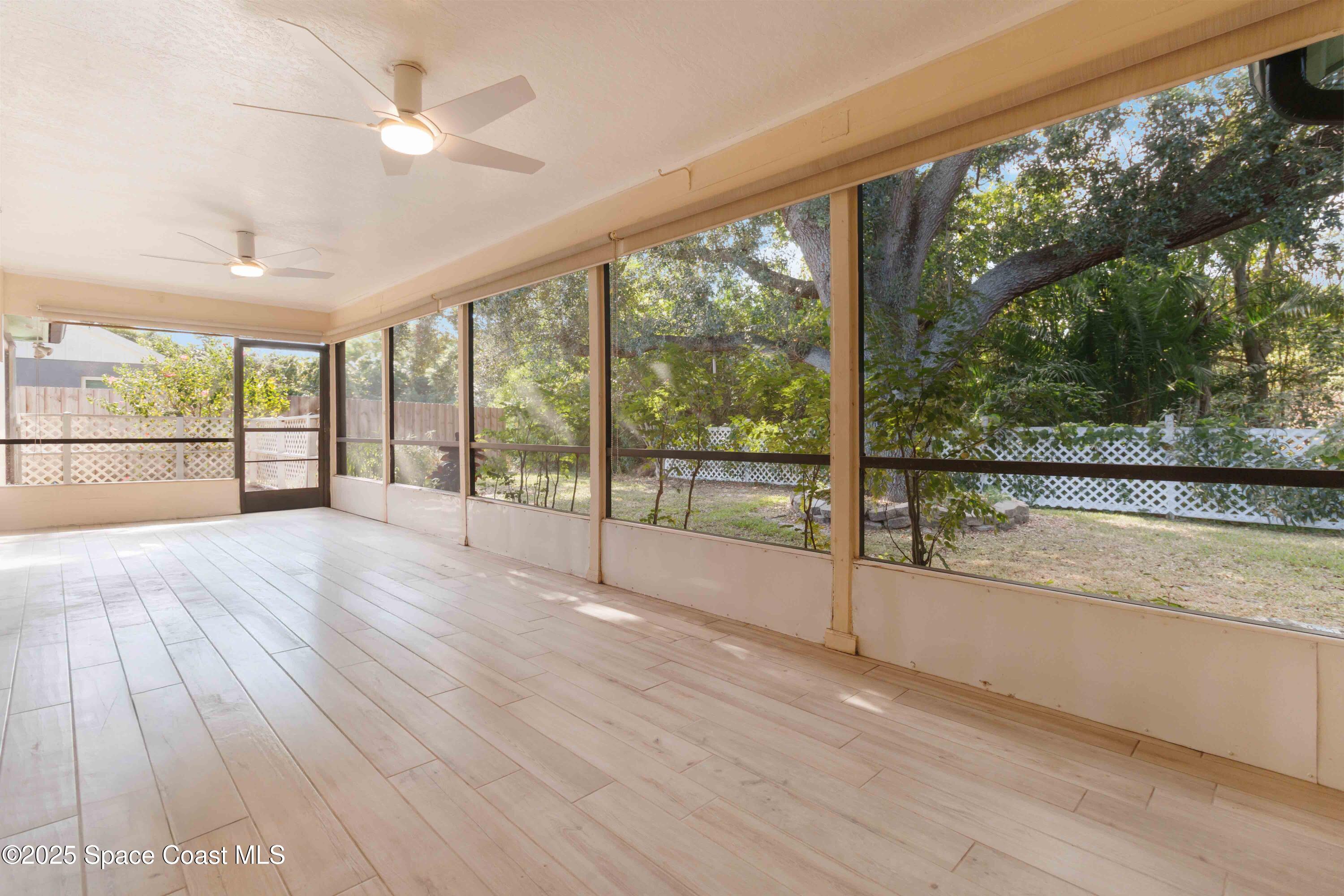 2355 Raintree Lake Circle Merritt Island, FL 32953 - Photo 37 of 47 an empty room with wooden floor and windows
