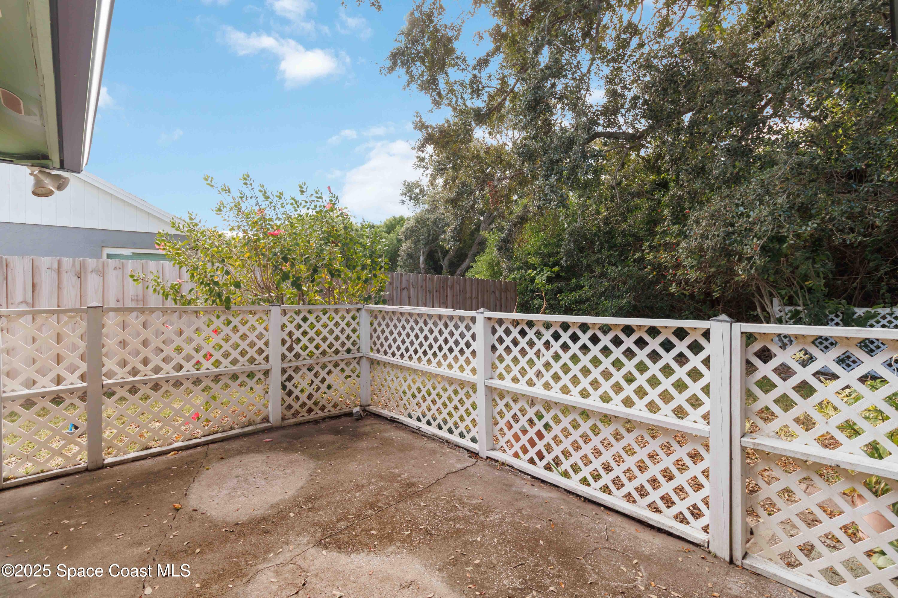 2355 Raintree Lake Circle Merritt Island, FL 32953 - Photo 38 of 47 a side view of a white building with wooden fence