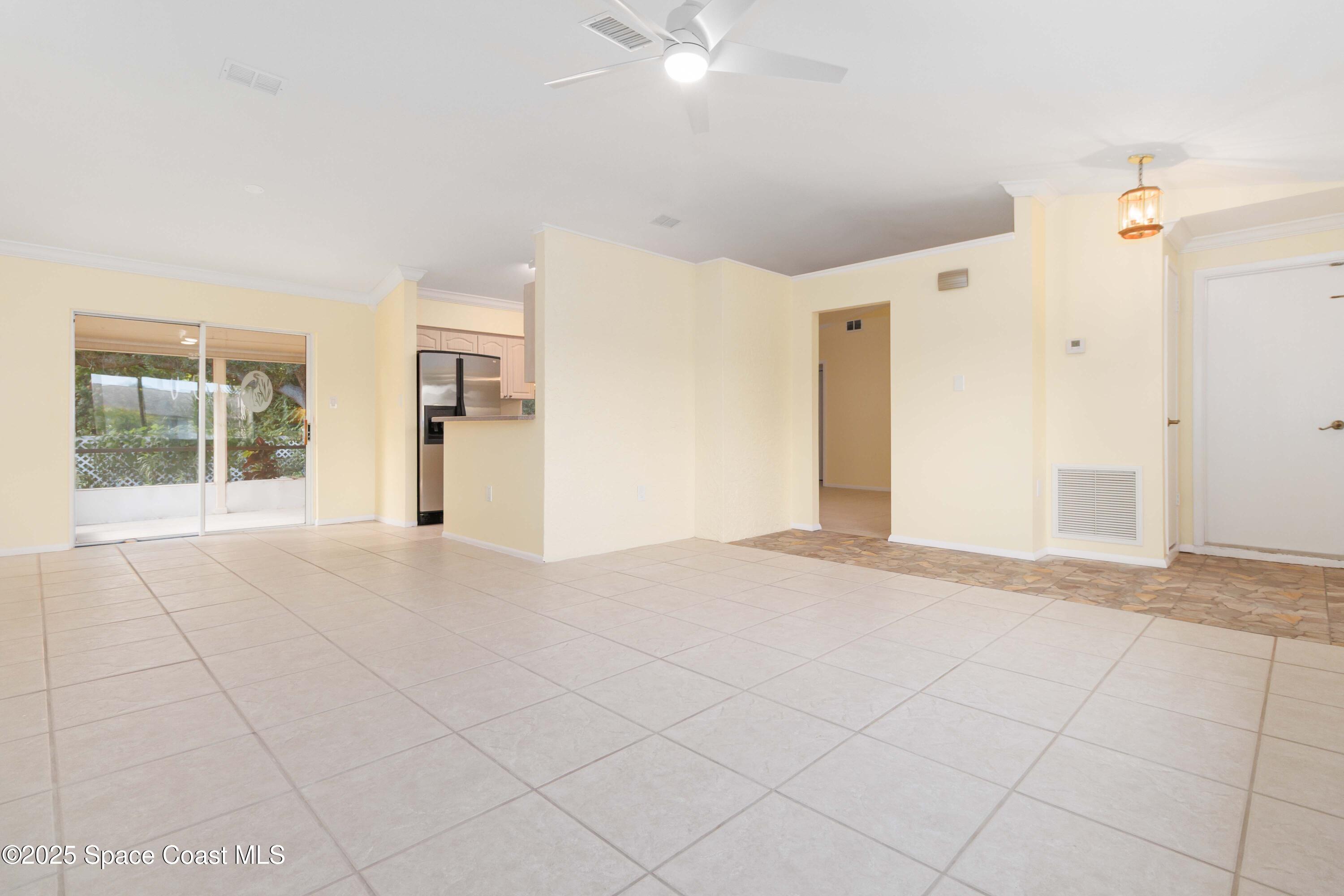 2355 Raintree Lake Circle Merritt Island, FL 32953 - Photo 7 of 47 a view of an empty room with window and chandelier fan