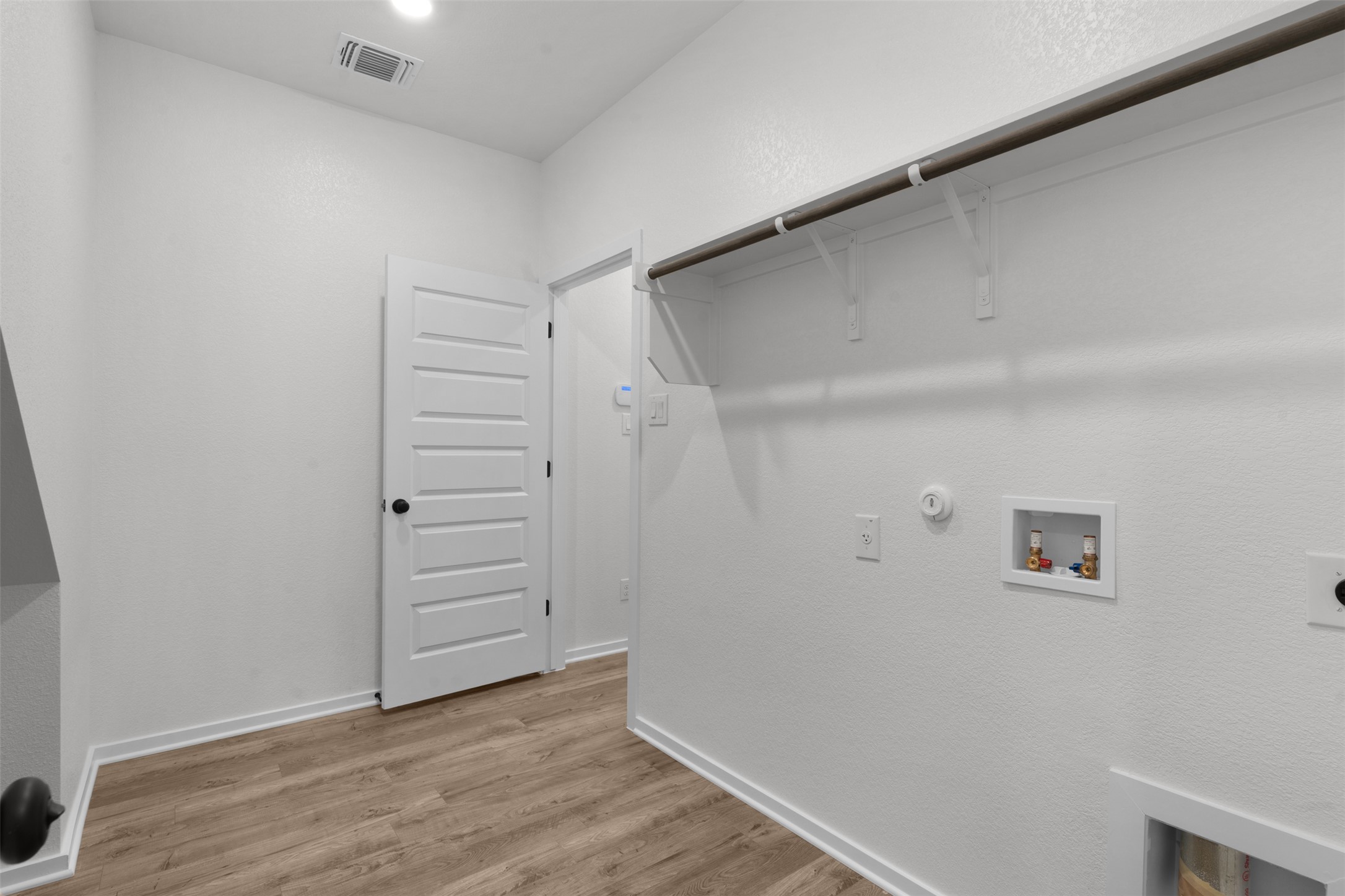 405 Raleigh Drive Georgetown, TX 78633 - Photo 13 of 27 Laundry room with hookup for a gas dryer, washer hookup, electric dryer hookup, and light wood finished floors
