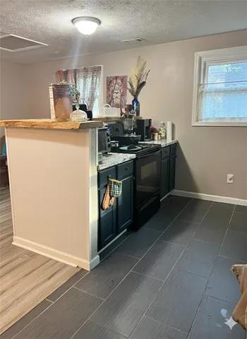 a kitchen with a stove and a refrigerator