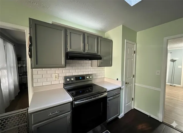 a kitchen with a refrigerator stove and cabinets