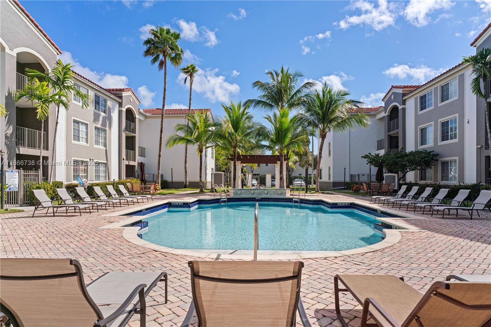 6851 Southwest 44th Street, Unit 106 Miami, FL 33155 - Photo 8 of 17 a swimming pool with outdoor seating and yard