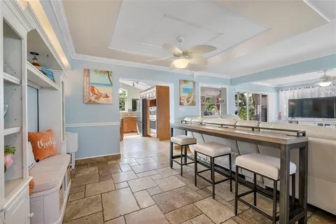 a kitchen with stainless steel appliances kitchen island granite countertop a table chairs in it and wooden floors