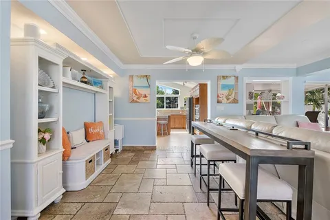 a kitchen with stainless steel appliances kitchen island granite countertop a table chairs in it and wooden floors