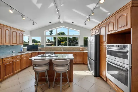 a kitchen with a sink stainless steel appliances and cabinets