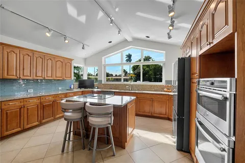 a kitchen with a sink stainless steel appliances and cabinets