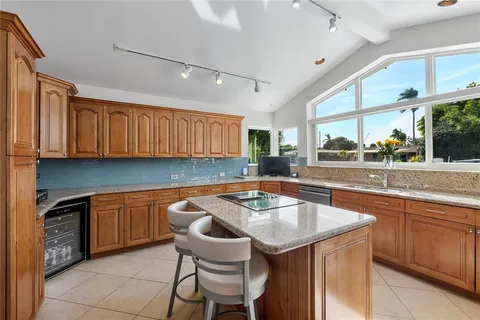 a kitchen that has a sink a oven and a table in it