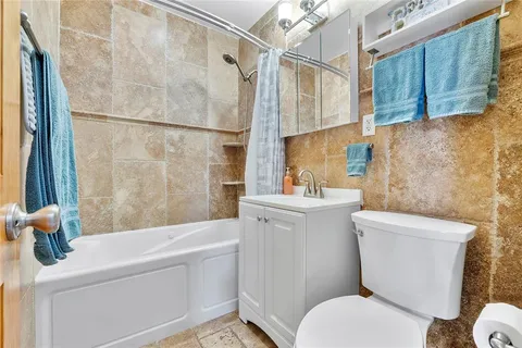 a white toilet sitting next to a bathroom sink