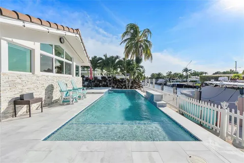 a view of a swimming pool with lounge chairs