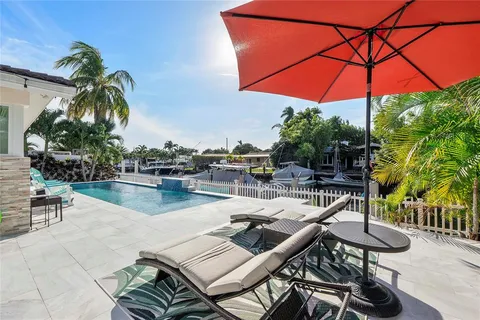 a view of a patio with a table and chairs under an umbrella