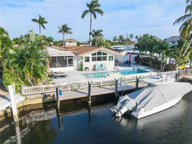 a view of a dining room with furniture a fireplace and a chandelier