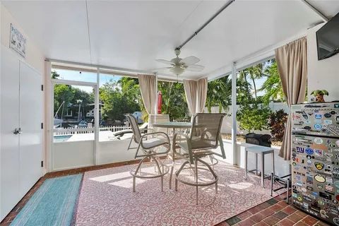 a view of a patio with a table and chairs under an umbrella