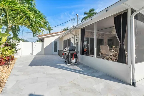 a front view of a house with a yard and potted plants