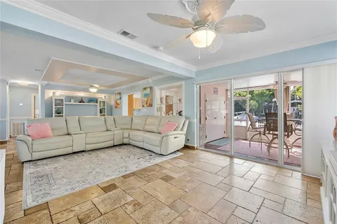 a living room with furniture and a chandelier