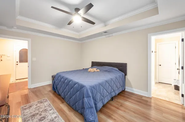 a bedroom with a bed and a view of bathroom