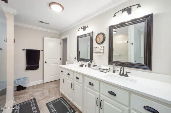 a spacious bathroom with a double vanity sink and a mirror