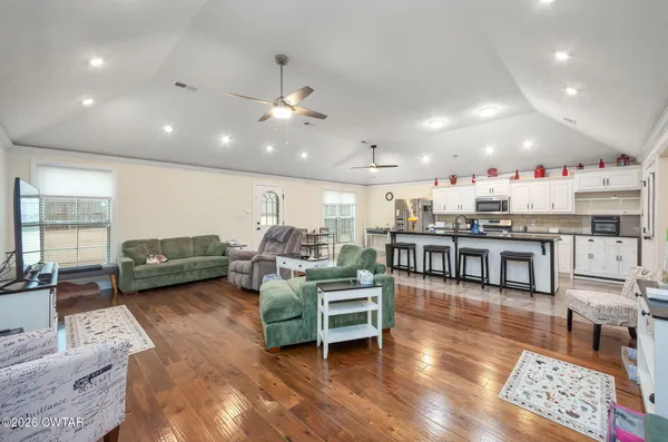 a living room with lots of furniture and kitchen view