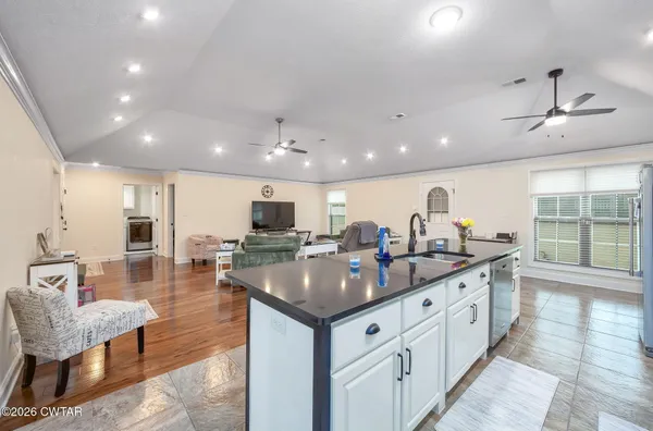 a kitchen with counter space appliances and a view of living room