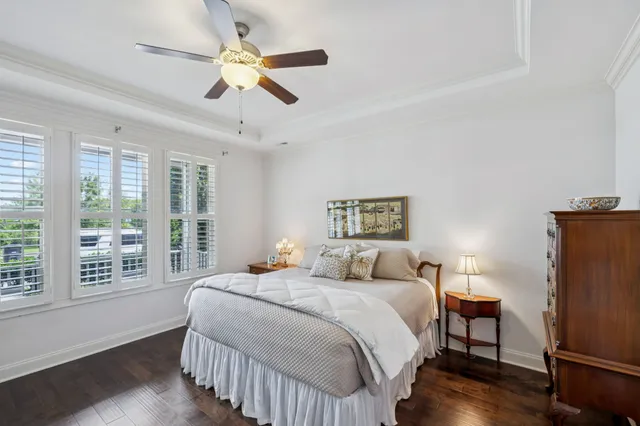 a bedroom with a large bed and a chandelier