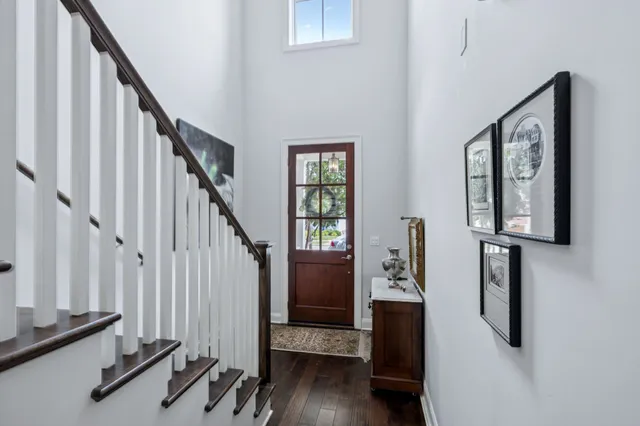 a view of hallway with stairs and wooden floor