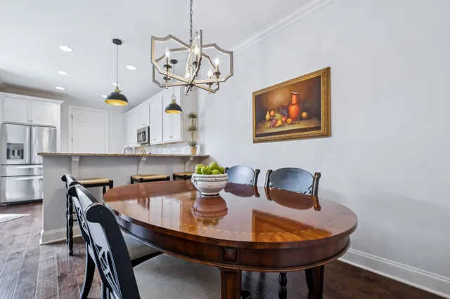 a view of a dining room with furniture wooden floor and chandelier