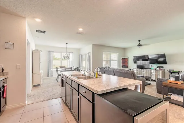 a large kitchen with a counter space and stainless steel appliances