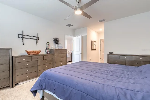 a bedroom with a bed and a dresser