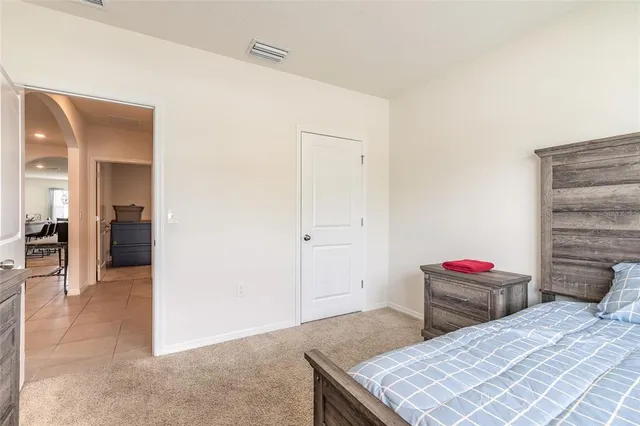 a bedroom with a bed and a lamp