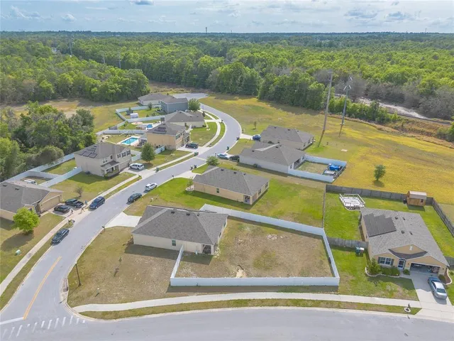 an aerial view of a house with a swimming pool