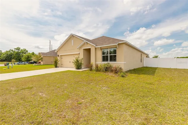 a view of an house with pool and a yard