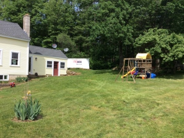 840 W Road New Braintree, MA 01531 - Photo 7 of 30 a view of a house with a backyard and a patio