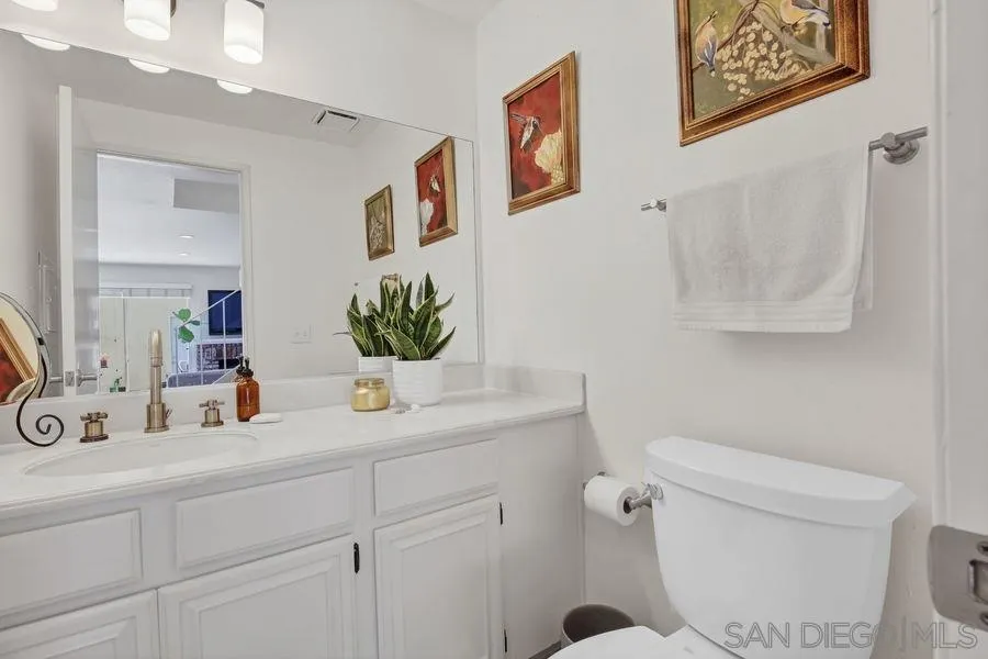 1758 Edgefield Lane Encinitas, CA 92024 - Photo 11 of 25 a bathroom with a toilet sink and mirror