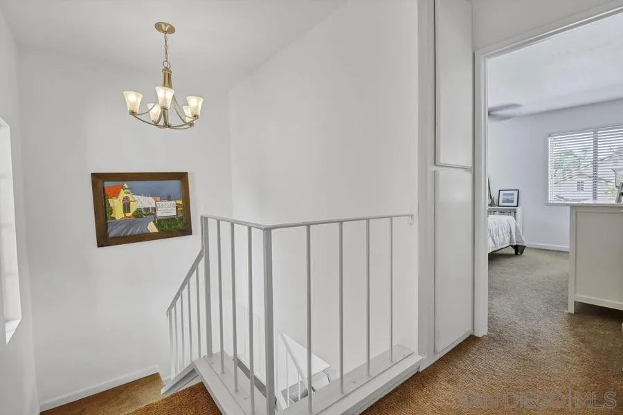 1758 Edgefield Lane Encinitas, CA 92024 - Photo 12 of 25 a view of a hallway with a chandelier
