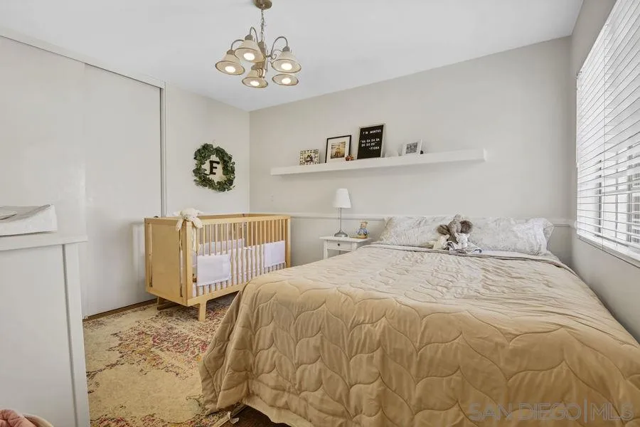 1758 Edgefield Lane Encinitas, CA 92024 - Photo 13 of 25 a spacious bedroom with a bed and a window