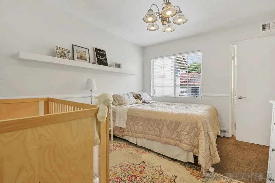 1758 Edgefield Lane Encinitas, CA 92024 - Photo 14 of 25 a bedroom with a bed and a table in it