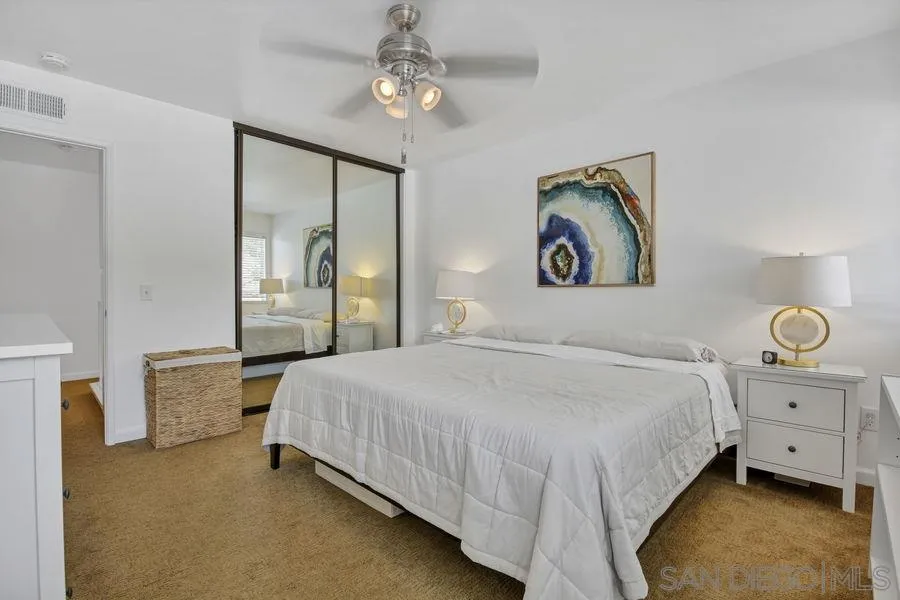 1758 Edgefield Lane Encinitas, CA 92024 - Photo 17 of 25 a bedroom with a bed and a chandelier