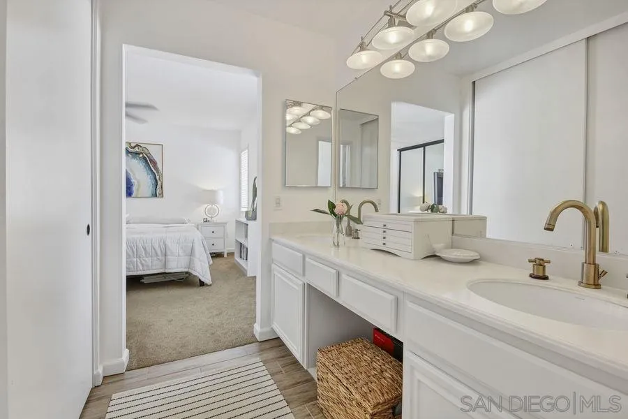 1758 Edgefield Lane Encinitas, CA 92024 - Photo 19 of 25 a en suite bathroom with a double vanity sink and a mirror