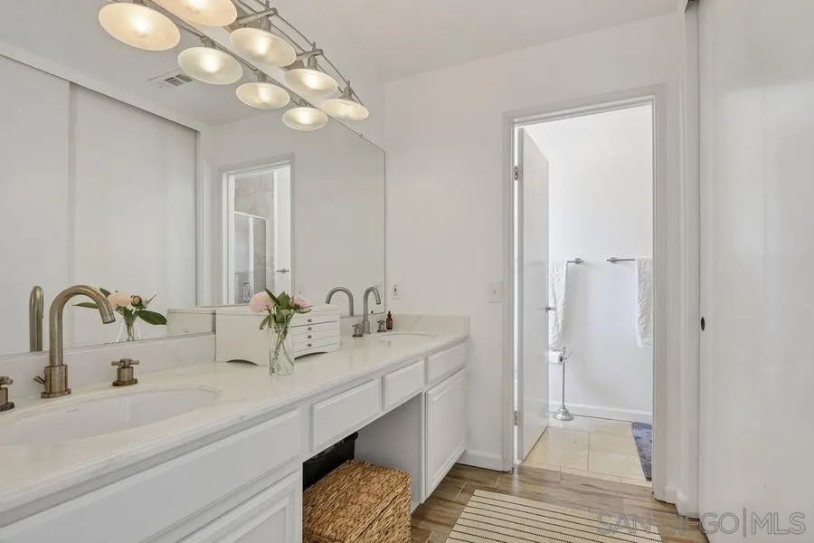 1758 Edgefield Lane Encinitas, CA 92024 - Photo 20 of 25 a bathroom with a sink and a mirror