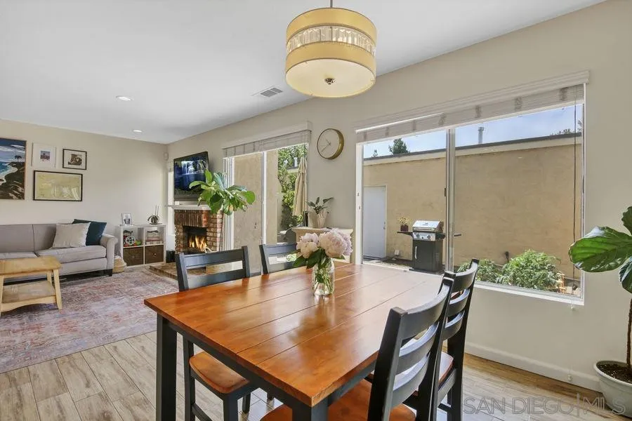 1758 Edgefield Lane Encinitas, CA 92024 - Photo 8 of 25 a view of a dining room and livingroom with furniture wooden floor a potted plant and a chandelier