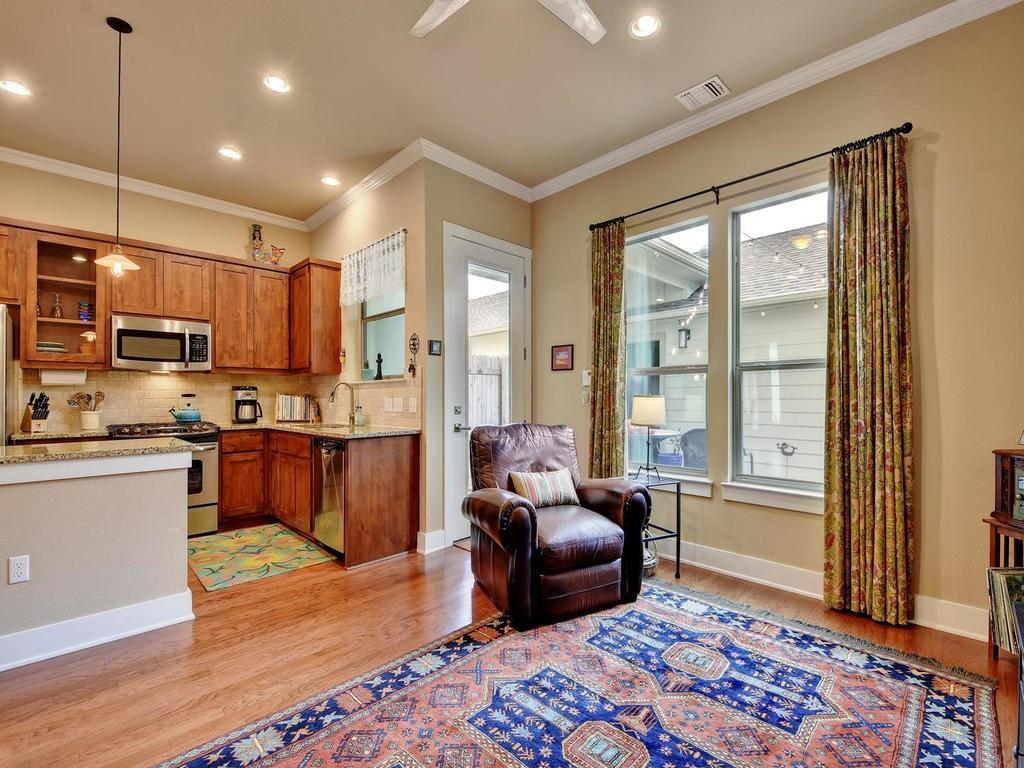 4545 Mattie Street Austin, TX 78723 - Photo 10 of 28 a living room with stainless steel appliances granite countertop furniture wooden floor and a rug