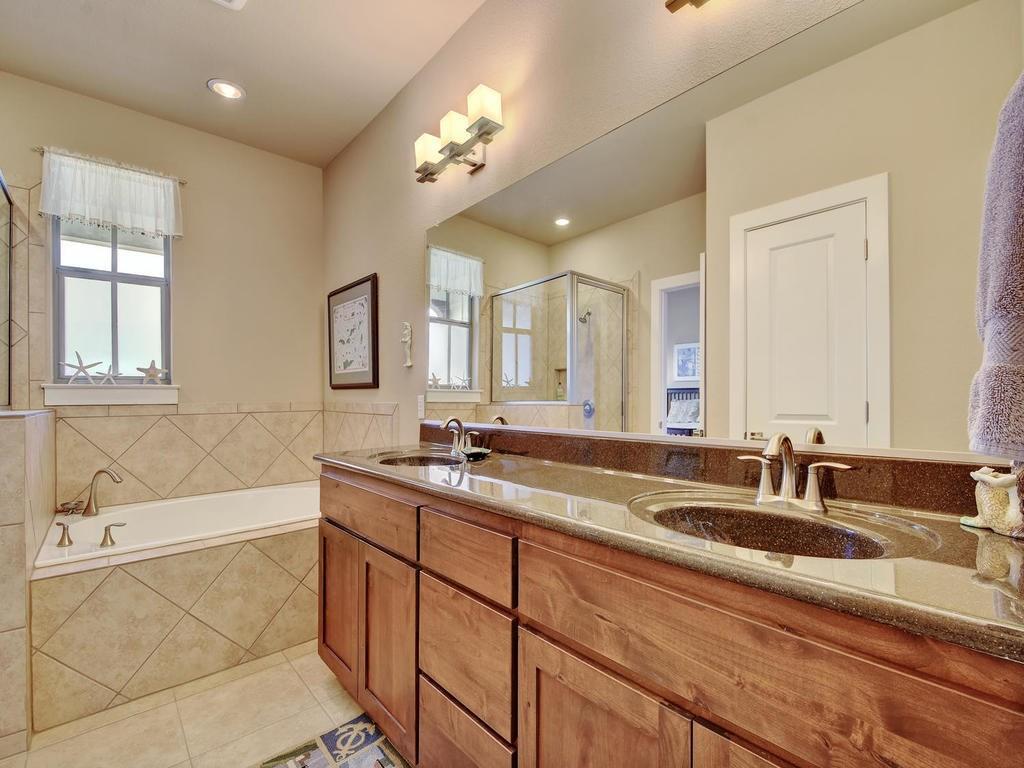 4545 Mattie Street Austin, TX 78723 - Photo 20 of 28 a bathroom with a sink double vanity granite tub and a mirror