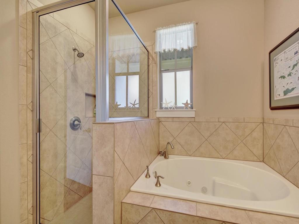4545 Mattie Street Austin, TX 78723 - Photo 21 of 28 a bathroom with a bathtub and a shower