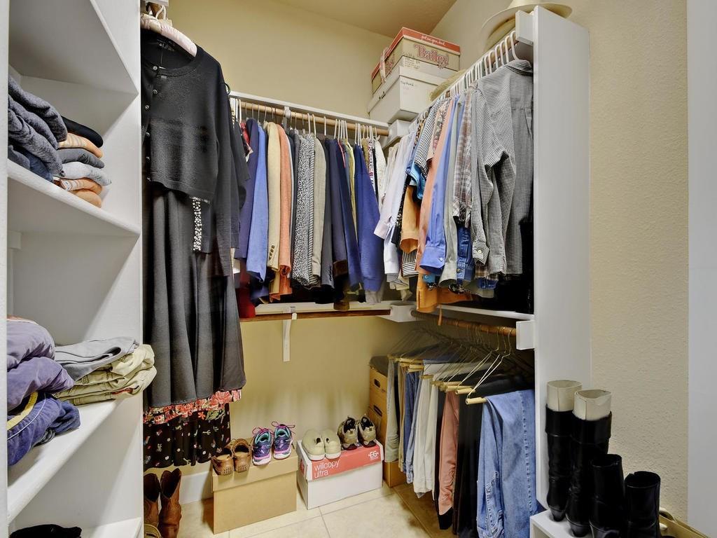4545 Mattie Street Austin, TX 78723 - Photo 22 of 28 a view of walk in closet with clothes and shoes