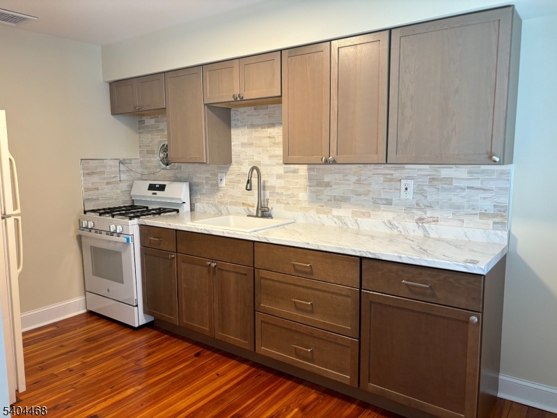 169 Union Road Roselle Park, NJ 07204 - Photo 2 of 7 a kitchen with stainless steel appliances granite countertop a sink stove and cabinets