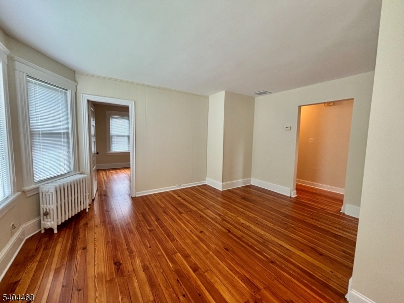 169 Union Road Roselle Park, NJ 07204 - Photo 4 of 7 wooden floor in an empty room with a window
