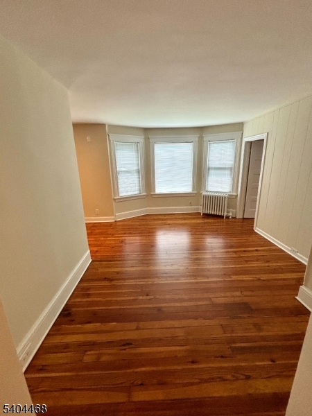 169 Union Road Roselle Park, NJ 07204 - Photo 5 of 7 a view of empty room with window and wooden floor