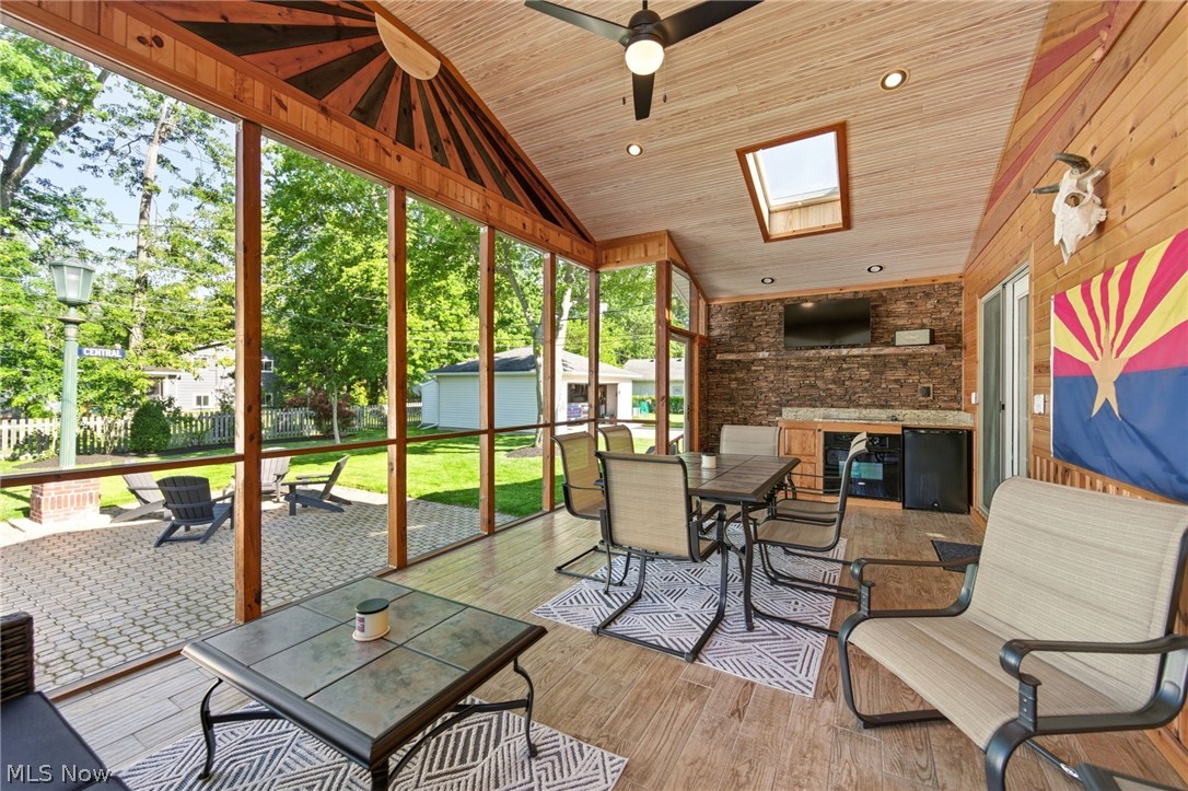 233 Sunset Road Avon Lake, OH 44012 - Photo 31 of 50 Screened-in porch featuring a vaulted wood-finish ceiling, skylight, and recessed lighting, stove and a fridge