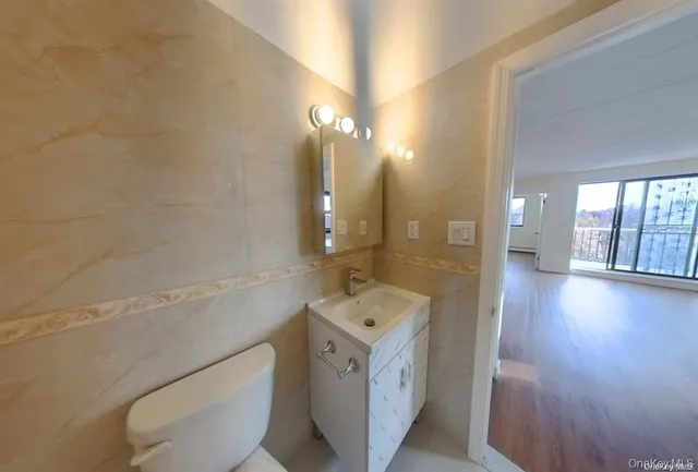 a bathroom with a toilet sink and mirror