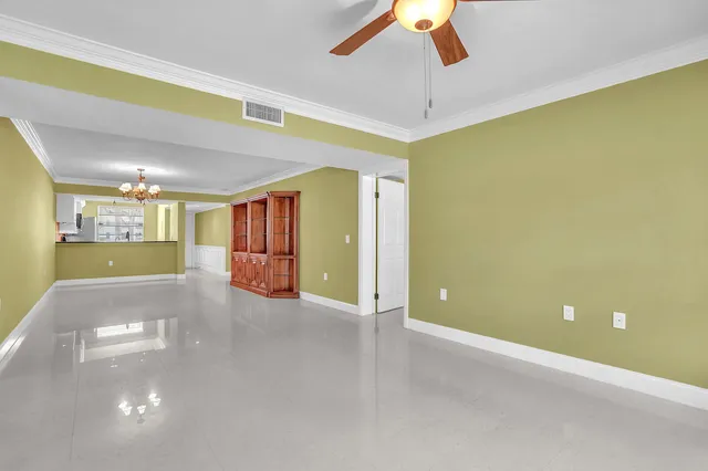 a view of an empty room with a ceiling fan